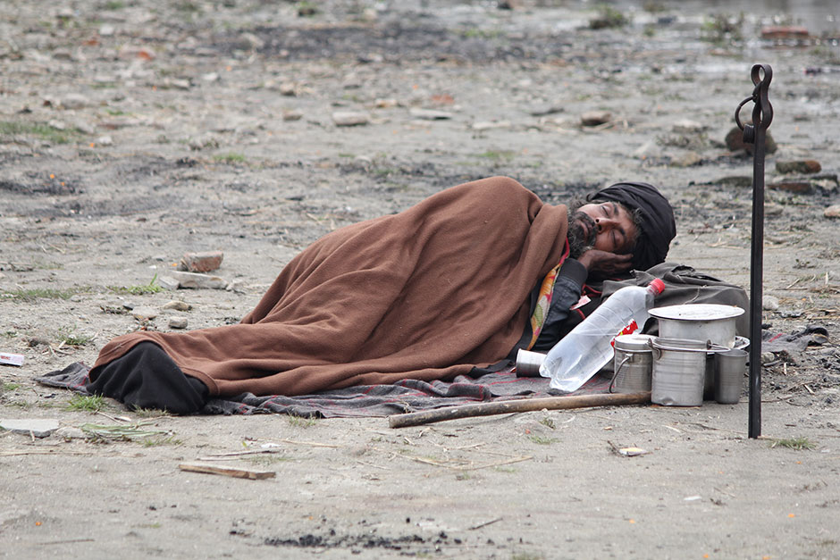 a hindu hermit lying beside the bank of holy river 