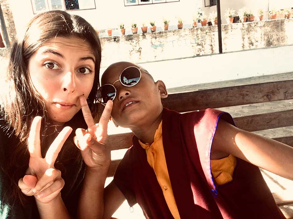 a volunteer taking photo with a girl in buddhist nunnery