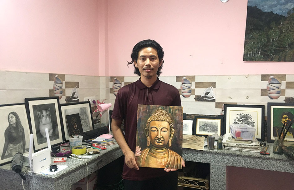 artist showing his buddha paint