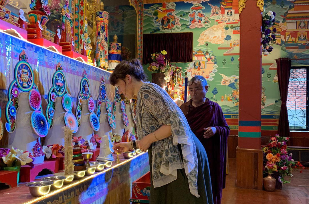 rebecca praying in buddhist temple   