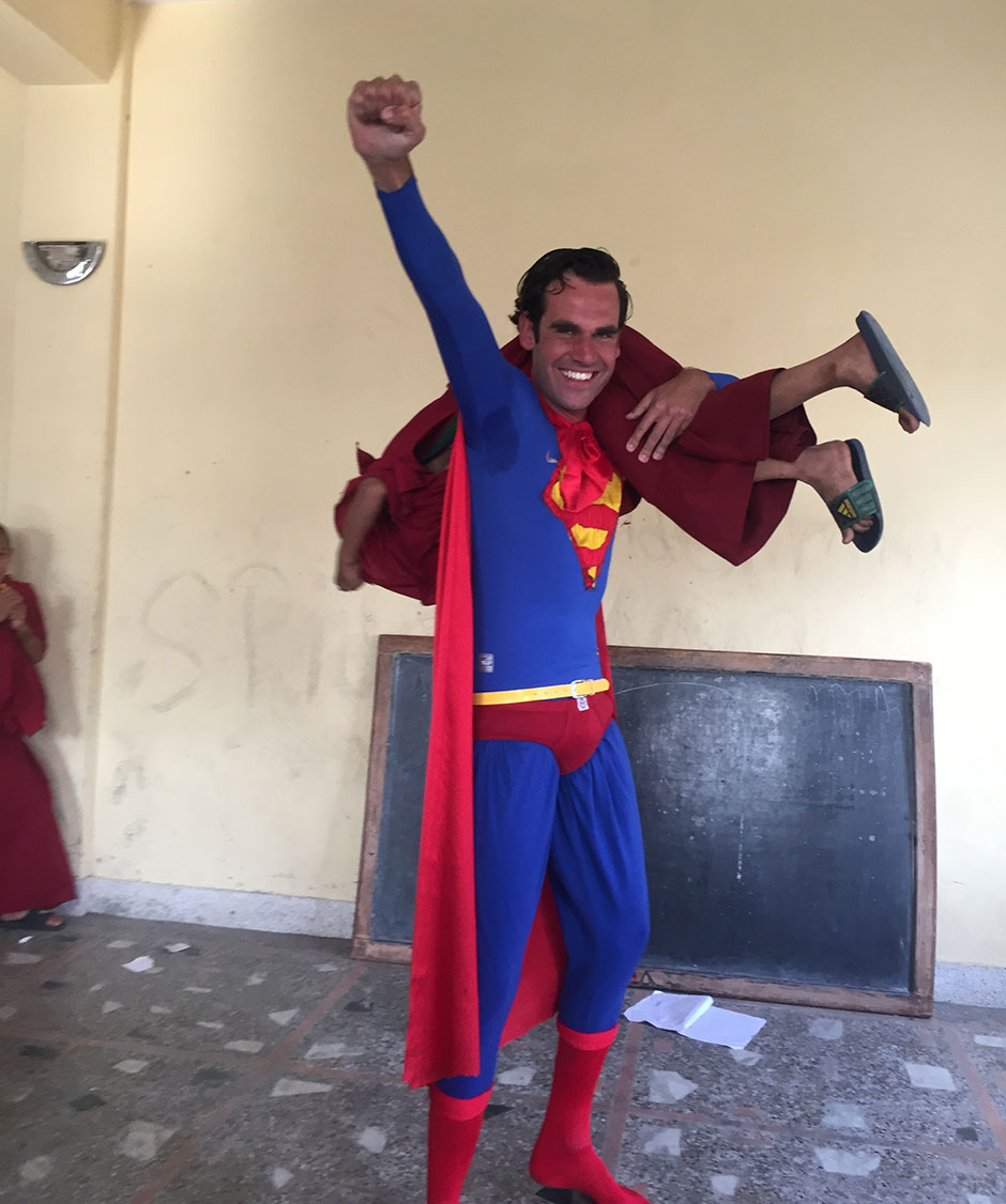 lammert joyfully lifting a monk kid as superman