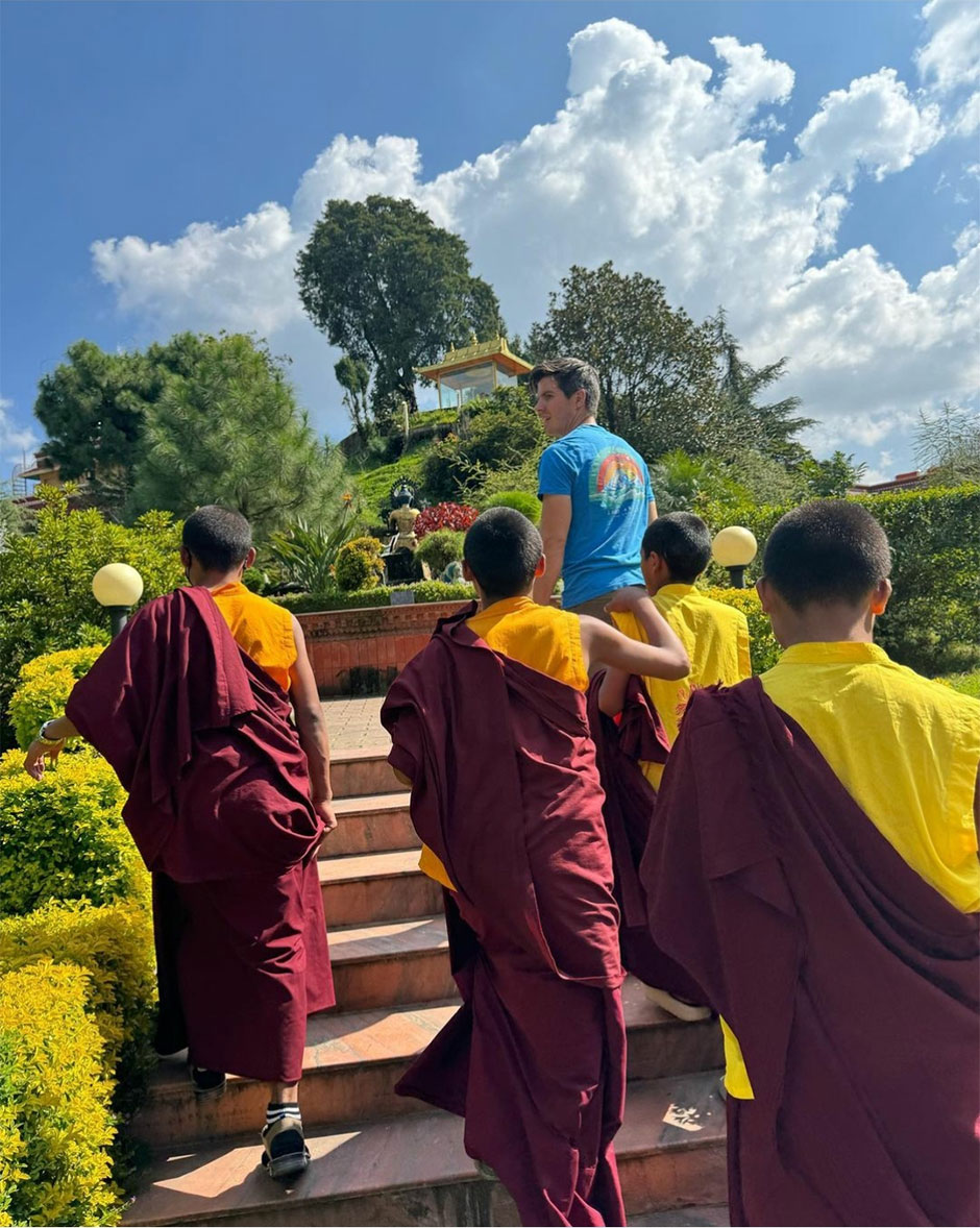 Patrick walking with monk kids in the Monastery
