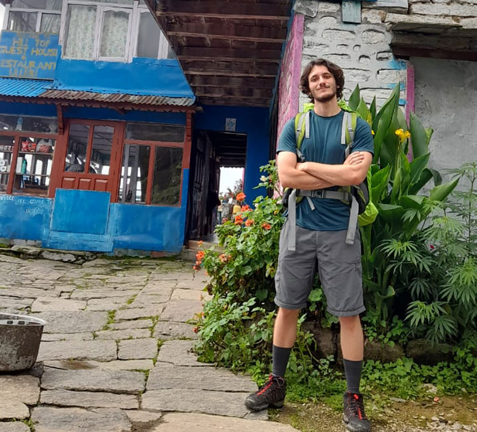 paul posing in front of a hotel in annapurna trail  
