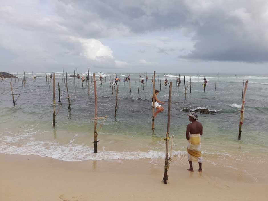 traveler in sri lanka with fishermen  