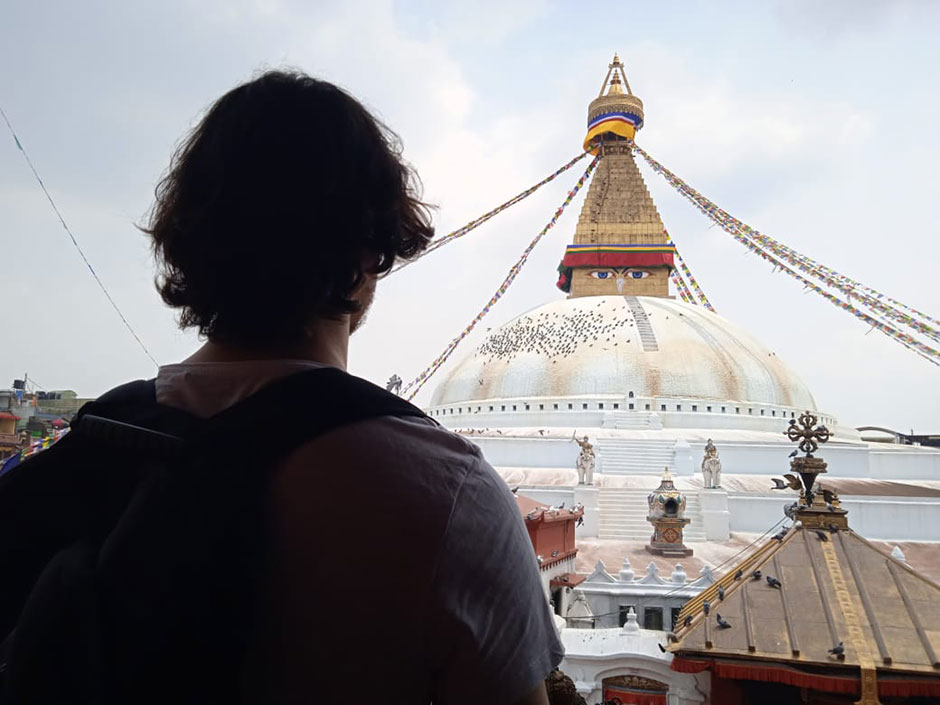 a volunteer in Nepal beholding buddhist temple 