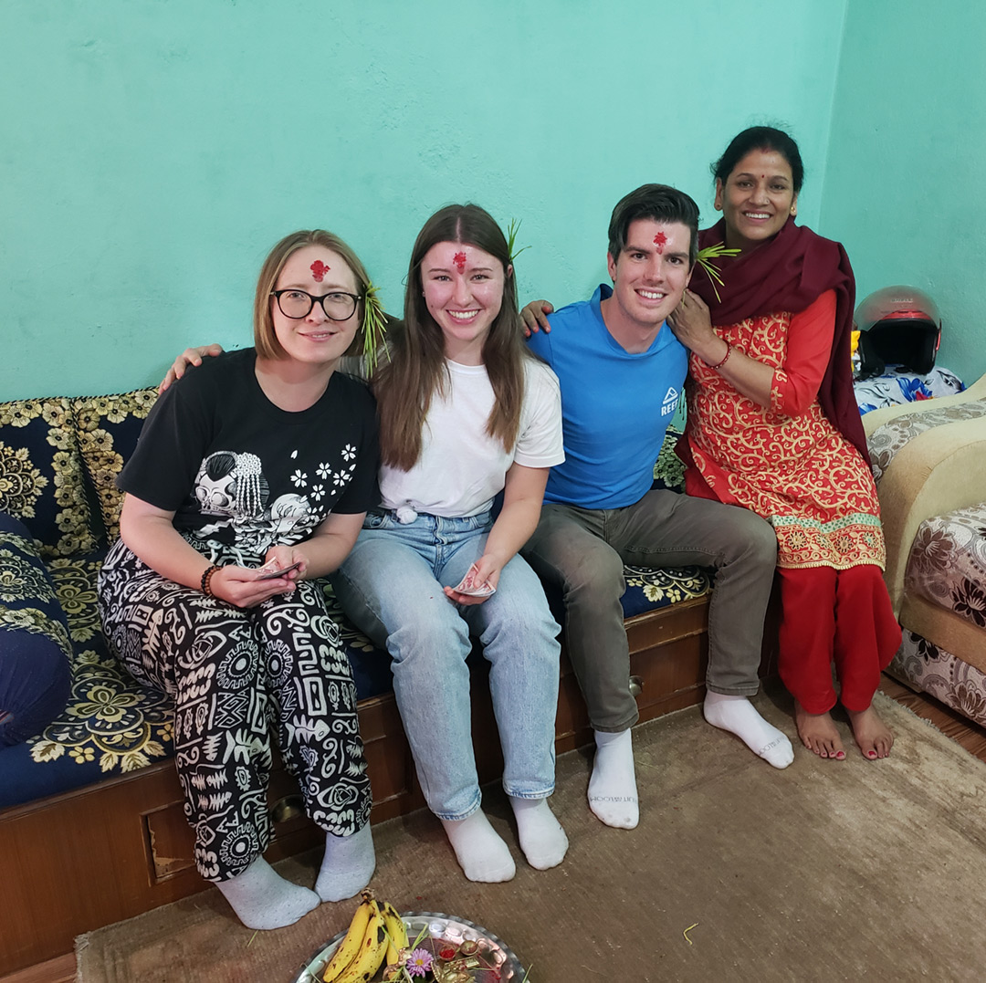 volunteers with host family